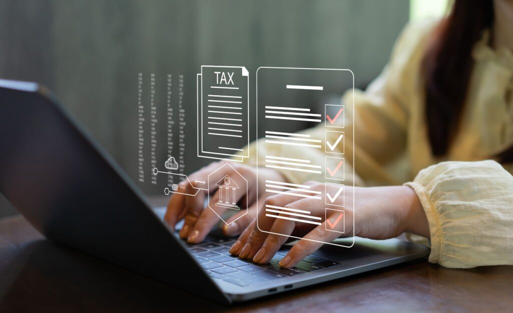 A close-up of a person typing on a laptop with a digital graphic overlay showing a tax document, data columns, and a checklist with red checkmarks.