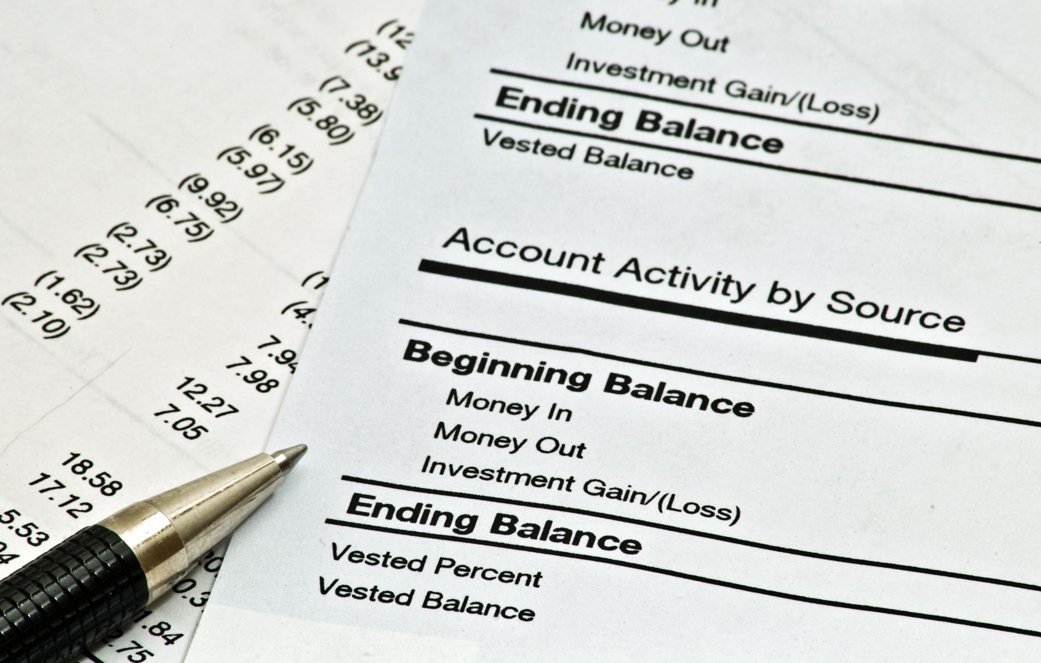 Financial account statement showing account activity and ending balance with a pen alongside.